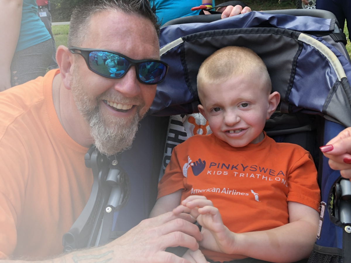 All-Star Brayden with his dad at a Pinky Swear Triathlon.