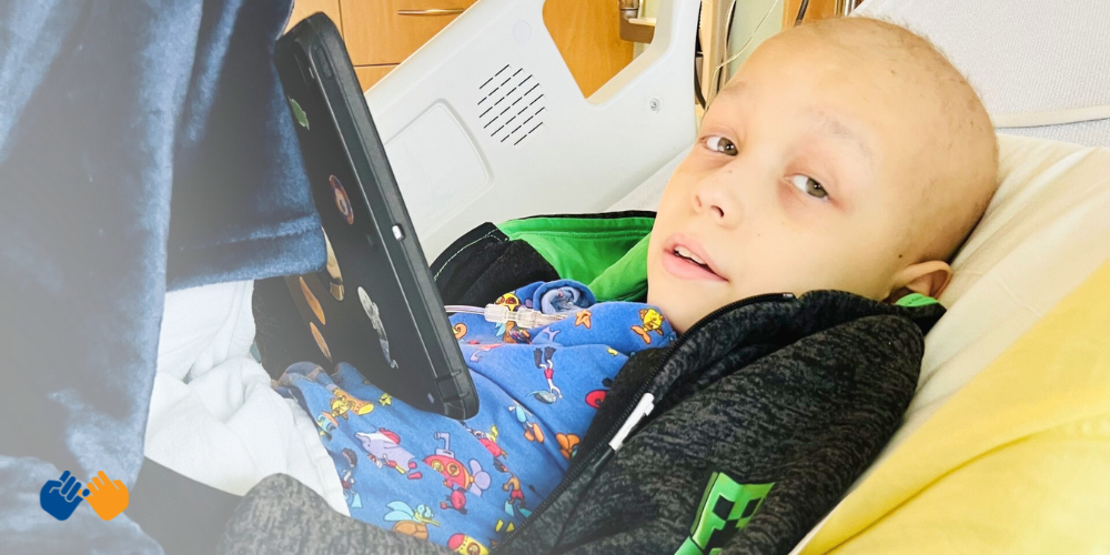 Pinky Swear All-Star Peter playing on his ipad while in the hospital battling medulloblastoma.