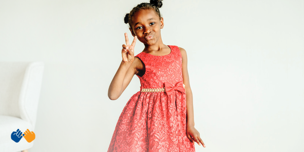 Pinky Swear All-Star Za'nari holding up the peace sign. Read her story!